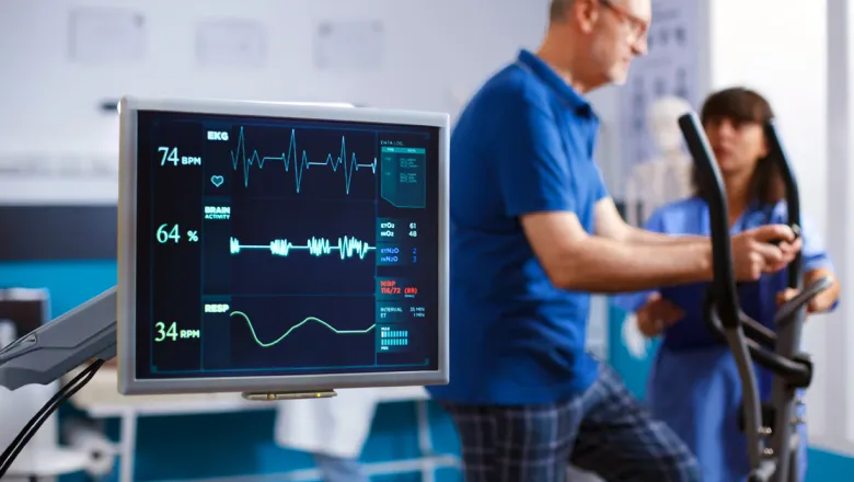 Cardiovascular technology professional working with a patient