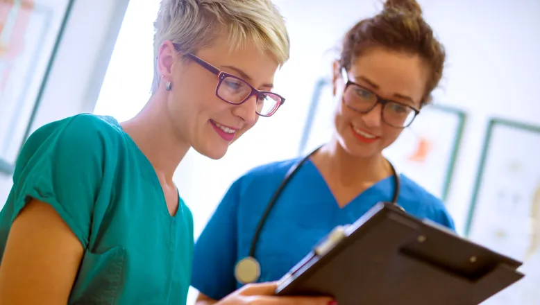 Two cardiovascular technology professionals reviewing a chart