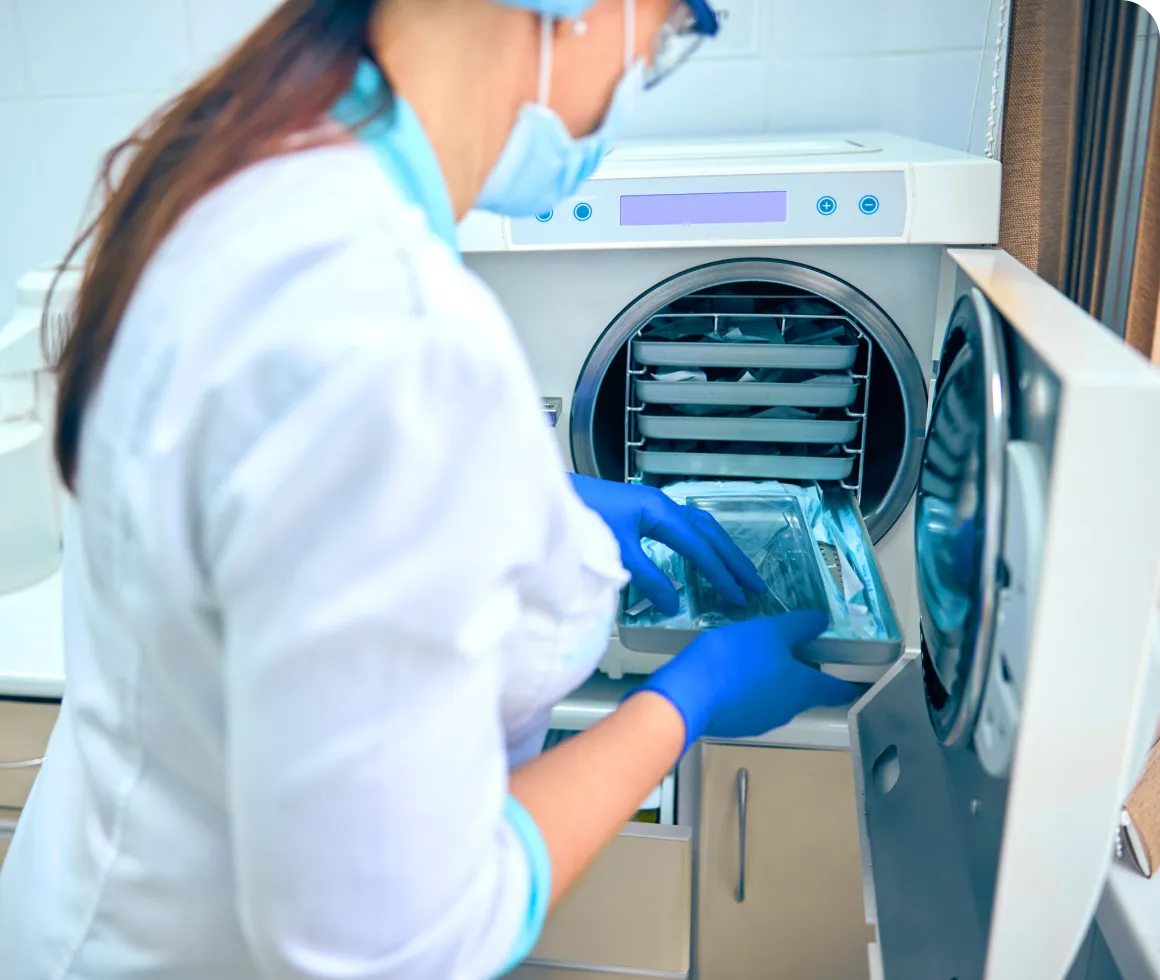 A healthcare professional sterilizing medical instruments