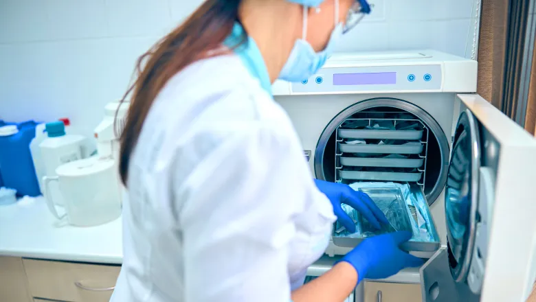 A healthcare professional sterilizing medical instruments