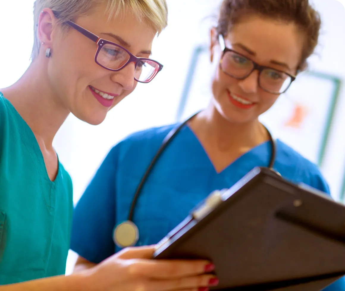 Two healthcare professionals reviewing charts