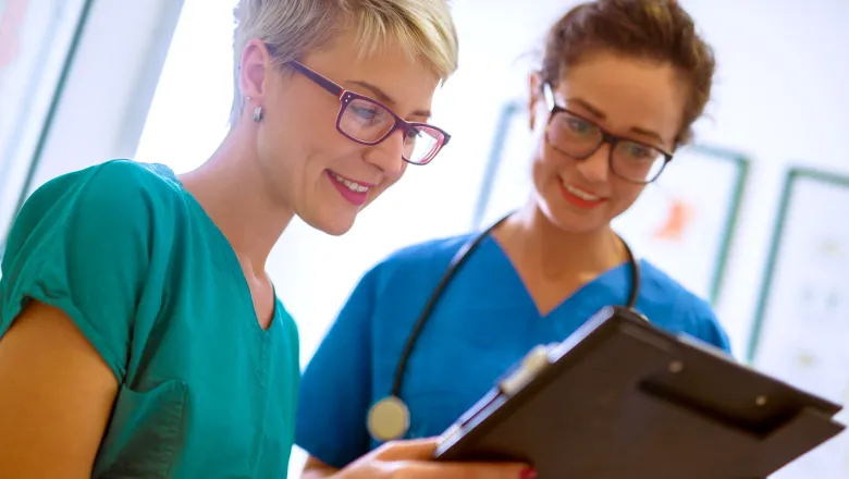 Two healthcare professionals reviewing charts